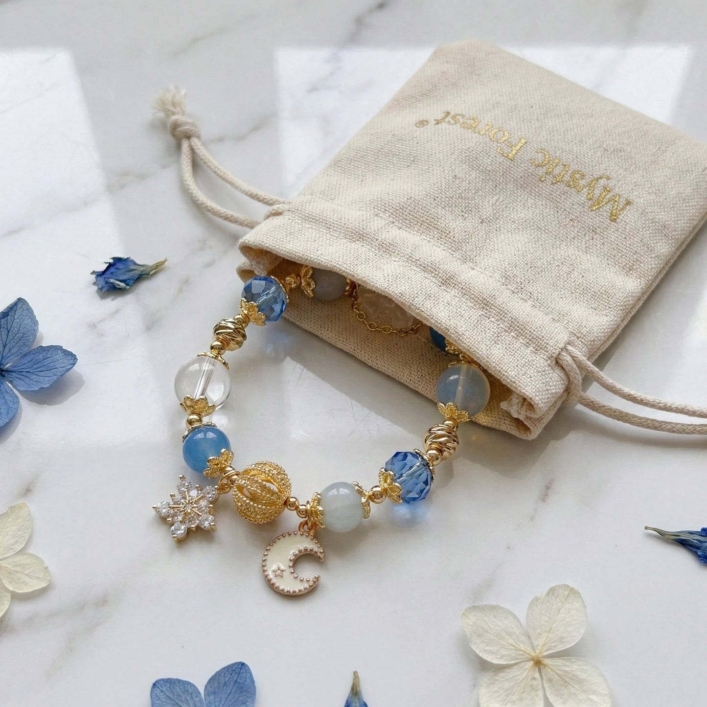 Moonlight Frost Bracelet – Blue crystal, opal, and clear quartz bring tranquility, magic, and winter elegance.